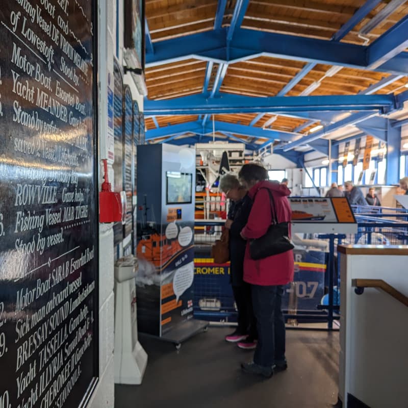 Two people interacting with a Donation Triggered Video plinth